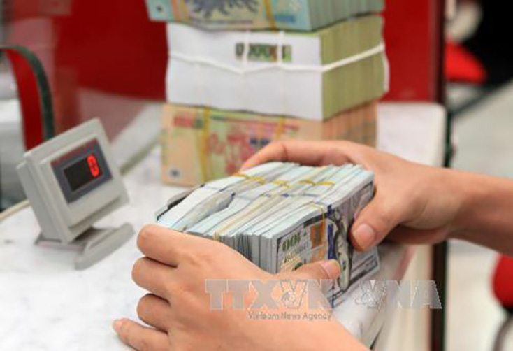  Tỷ giá trung tâm giảm 3 đồng, giá USD biến động mạnh. Ảnh minh họa: TTXVN