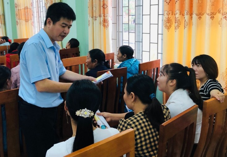  Cán bộ BHXH huyện Tuyên Hóa đang tuyên truyền, vận động người dân tham gia BHXH tự nguyện.