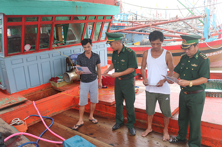 Cán bộ, chiến sỹ BĐBP tỉnh cấp phát tài liệu tuyên truyền PBGDPL cho ngư dân phường Quảng Phúc, TX. Ba Đồn (trước thời điểm dịch Covid-19 bùng phát).