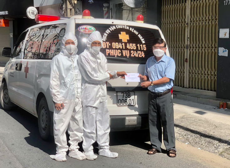 Ông Nguyễn Văn Dưỡng, Phó Chủ tịch Hội đồng hương Quảng Bình tại TP. Hồ Chí Minh trao quà động viên hai bố con anh Trí trước khi về quê chống dịch