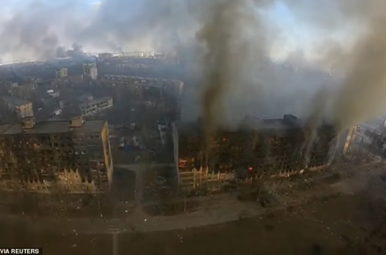 An aerial view shows smoke rising from damaged residential buildings following an explosion in Mariupol on Friday