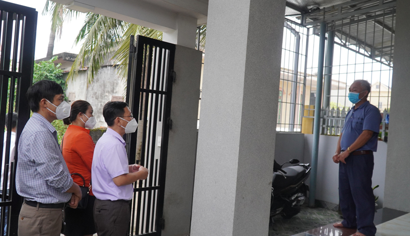 Cán bộ CDC trao đổi, hướng dẫn cách chăm sóc và xử lý rác thải đối với gia đình đang có trường hợp F0 cách ly điều trị tại nhà cho người dân TP. Đồng Hới.