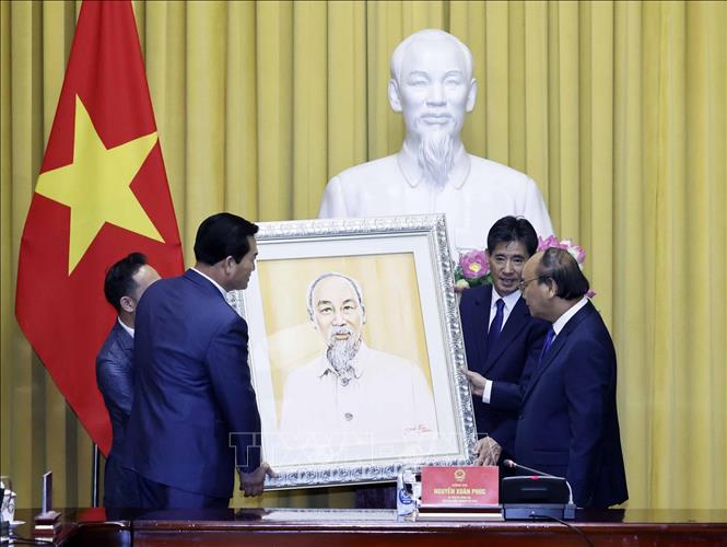 Ông Kim Kil-soo, Chủ tịch Hiệp hội Kinh tế, Văn hóa Hàn Quốc – Việt Nam tặng Chủ tịch nước Nguyễn Xuân Phúc chân dung Chủ tịch Hồ Chí Minh. Ảnh: Thống Nhất/TTXVN