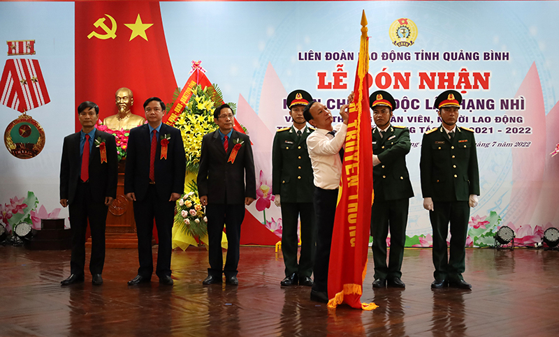 Thừa ủy quyền của Chủ tịch nước, đồng chí Phó Bí thư Thường trực Tỉnh ủy Trần Hải Châu gắn Huân chương Độc lập hạng Nhì lên lá cờ truyền thống của LĐLĐ tỉnh.