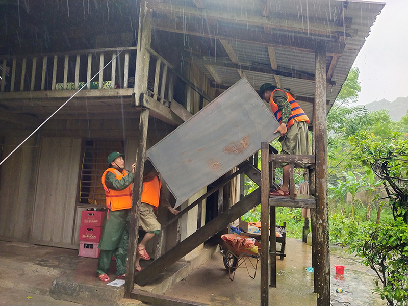  Cán bộ chiến sỹ Đồn Biên phòng Làng Mô giúp người dân di chuyển đồ đạc lên cao để tránh thiệt hại.