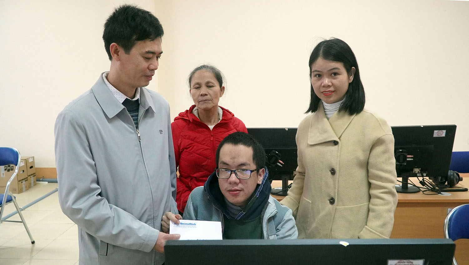 Đại diện lãnh đạo Báo Quảng Bình trao tiền hỗ trợ cho em Nguyễn Văn Thắm