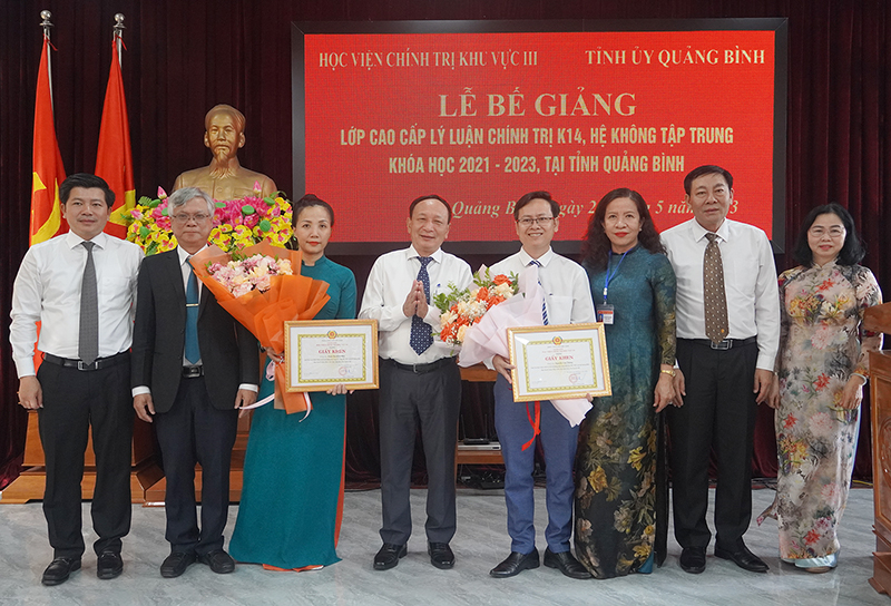 Các đồng chí lãnh đạo tỉnh, Học viện Chính trị khu vực III, Trường Chính trị Quảng Bình tặng hoa chúc mừng các học viên xuất sắc của khóa học.