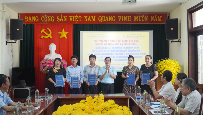 Đại diện lãnh đạo Sở VH-TT trao sách cho các đơn vị trực thuộc để ứng dụng kết quả đề tài vào thực tiễn.