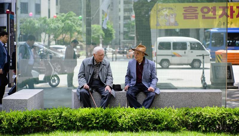 Hai người đàn ông lớn tuổi trò chuyện ở thủ đô Seoul, Hàn Quốc ngày 11/5/2023. Ảnh: AFP