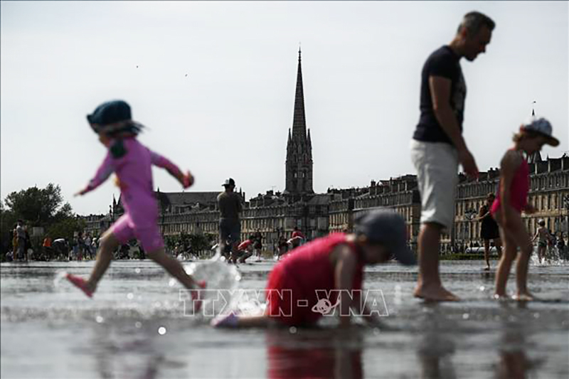  Người dân giải nhiệt tránh nóng tại khu vực đài phun nước ở Bordeaux, Pháp. Ảnh tư liệu: AFP/TTXVN