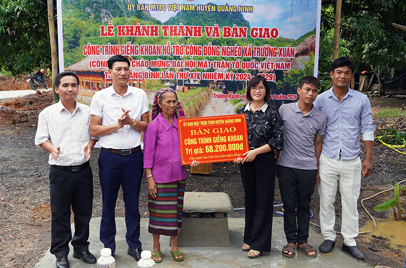Đại diện lãnh đạo Ủy ban MTTQVN huyện Quảng Ninh và chính quyền địa phương bàn giao giếng cho người dân bản Khe Dây.