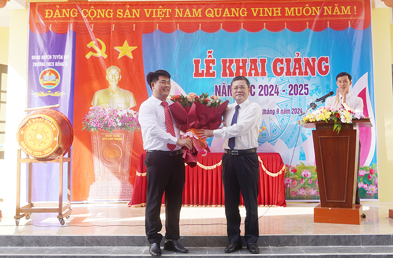 Đồng chí Phan Phong Phú tặng hoa chúc mừng Trường THCS Đồng Lê nhân dịp năm học mới.