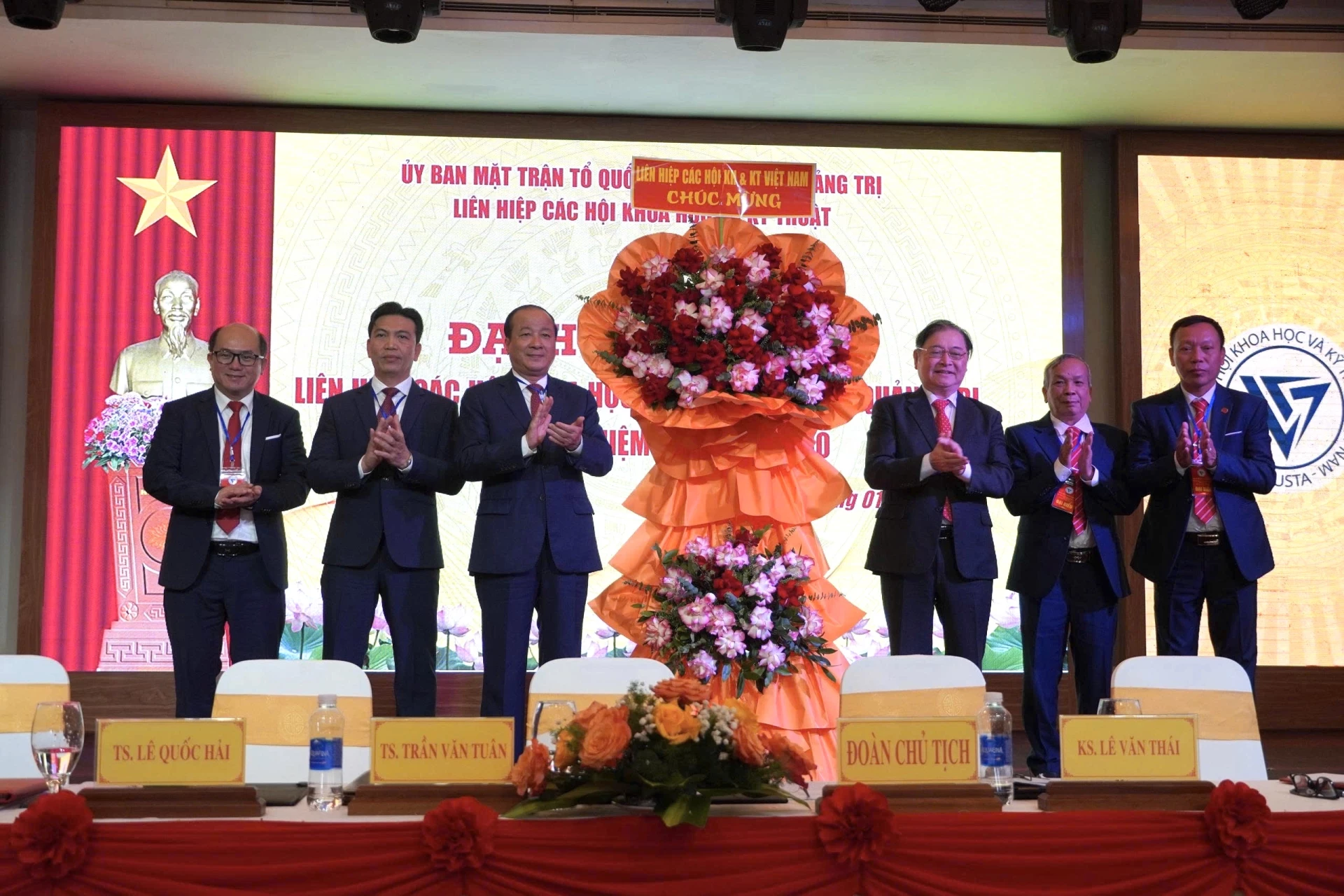 Ông Phan Xuân Dũng - Chủ tịch Liên hiệp các Hội Khoa học và Kỹ thuật Việt Nam tặng hoa chúc mừng Đại hội - Ảnh: NL