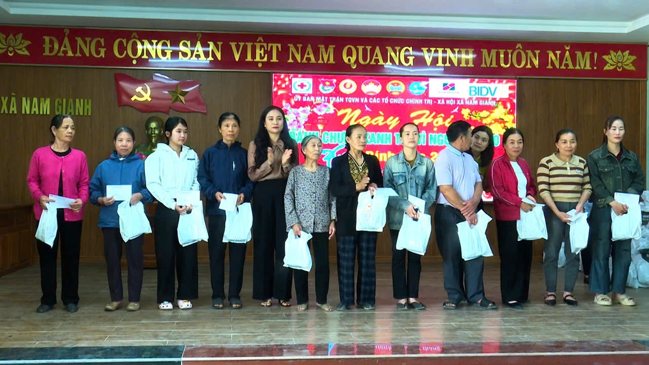 Đại diện Ủy ban MTTQ Việt Nam xã Nam Gianh trao bánh chưng và quà cho các hộ gia đình khó khăn - Ảnh: T.T