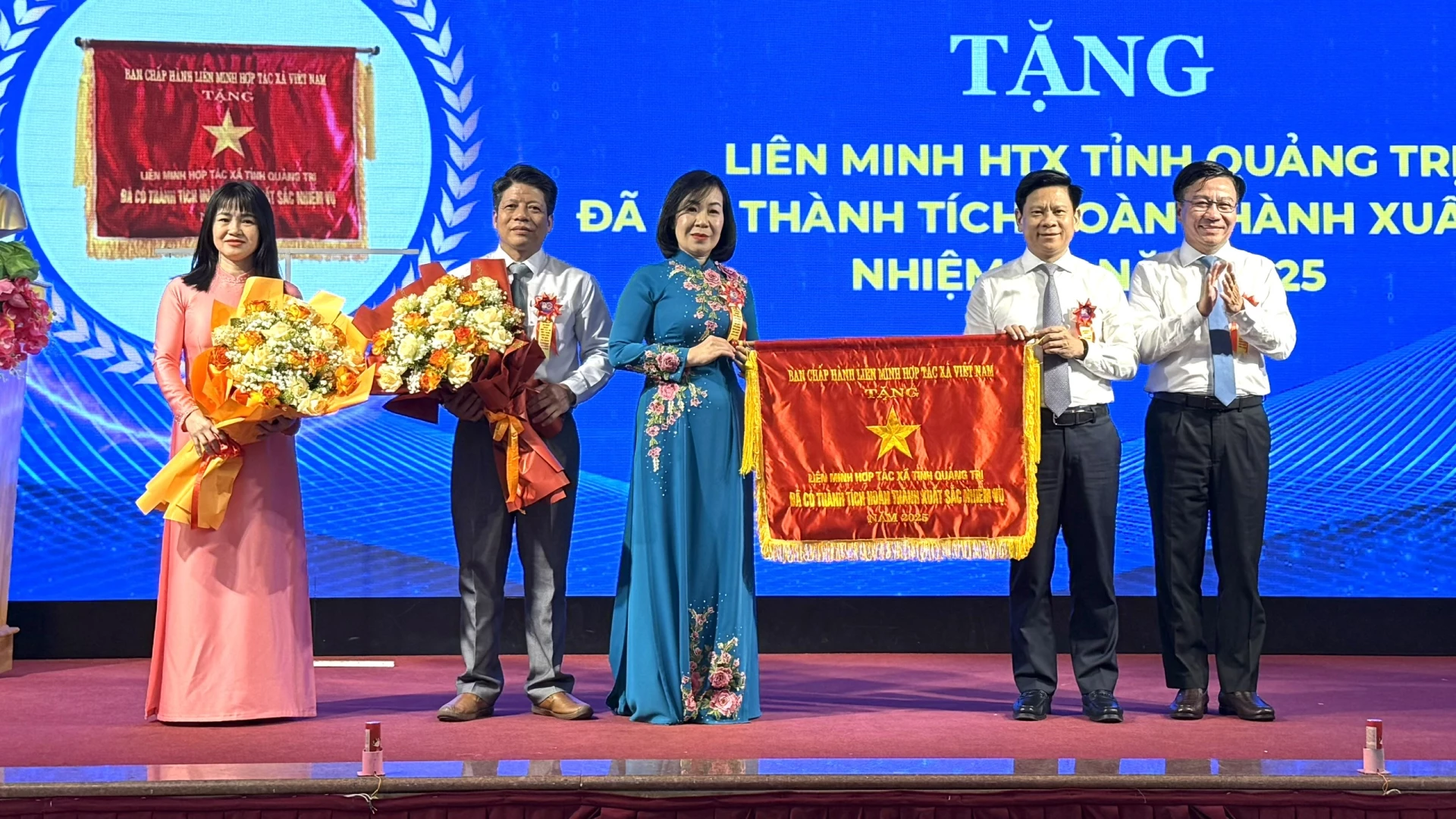 Đồng chí Đào Mạnh Hùng, Ủy viên Ban Thường vụ Tỉnh ủy, Phó Chủ tịch Thường trực Ủy ban MTTQ Việt Nam tỉnh và đồng chí Lê Vĩnh Thế, Ủy viên Ban Thường vụ Tỉnh ủy, Chánh Văn phòng Tỉnh ủy trao tặng Cờ thi đua của Ban chấp hành Liên minh HTX Việt Nam cho Liên minh HTX tỉnh Quảng Trị - Ảnh: NL