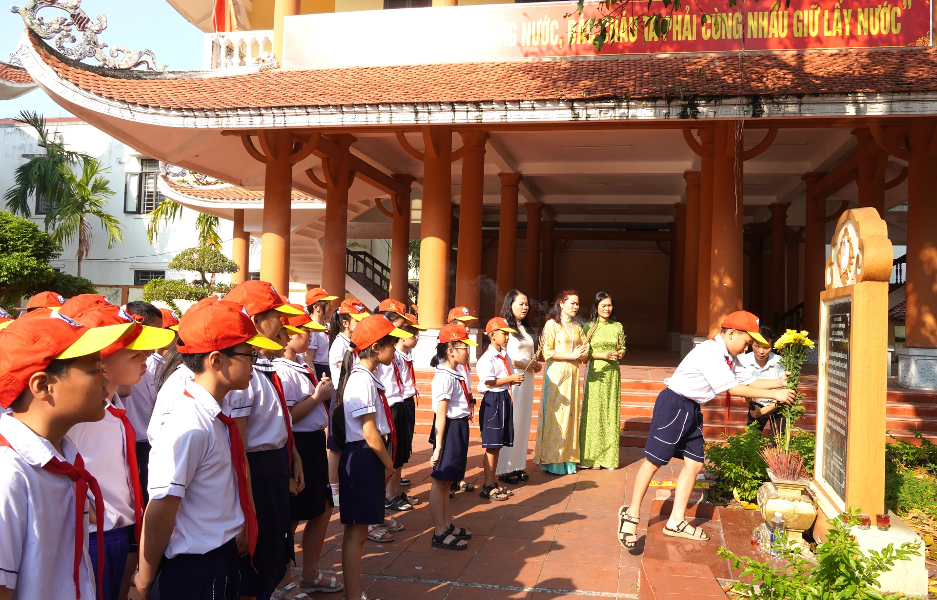 Cô và trò Trường tiểu học Hải Đình dâng hoa, dâng hương tại di tích Cây Đa-Chùa Ông - Ảnh: H.TR