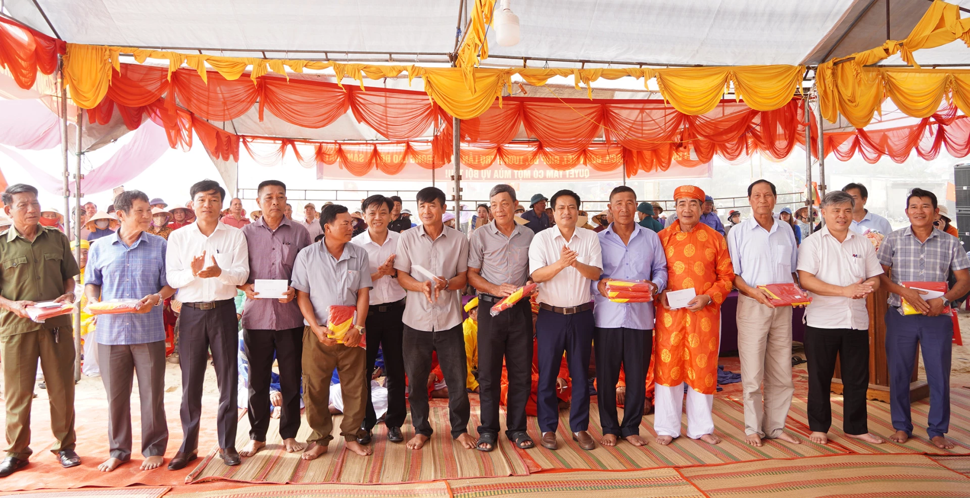 Đại diện lãnh đạo xã Nam Trạch, Sở Nông nghiệp và Môi trường, Sở Văn hóa, Thể thao và Du lịch trao tặng cờ và quà cho các tổ hợp tác, tàu cá - Ảnh: L.M