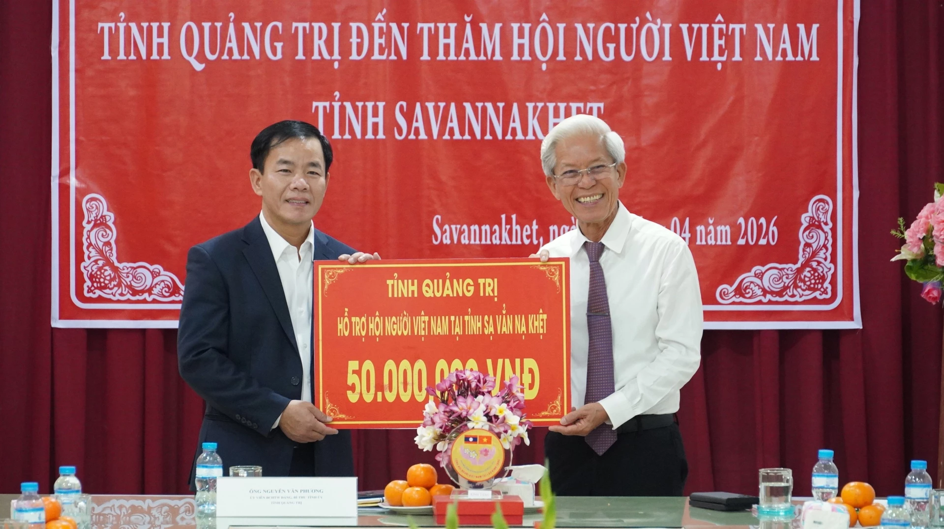 Đồng chí Bí thư Tỉnh ủy Nguyễn Văn Phương trao tặng Hội người Việt tại tỉnh Sạ-vẳn-nạ-khệt (Lào) số tiền 50 triệu đồng - Ảnh: Q.V