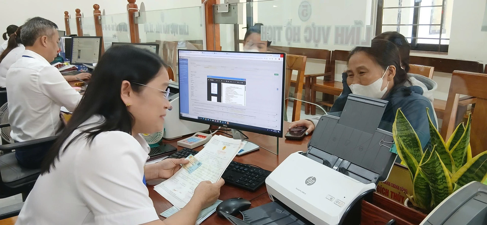  Cán bộ Trung tâm Phục vụ hành chính công xã Phong Nha hướng dẫn người dân thực hiện các thủ tục hành chính - Ảnh: H.Đ