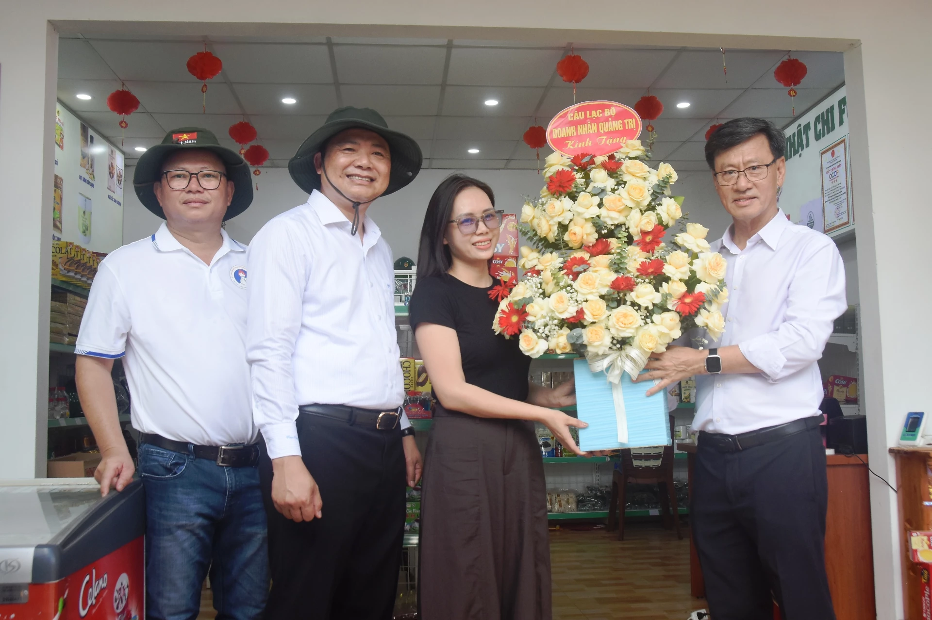 Đại diện CLB Doanh nhân Quảng Trị trao tặng hoa cơ sở Nhật Chi Food tại phường Quảng Trị - Ảnh: Đ.V