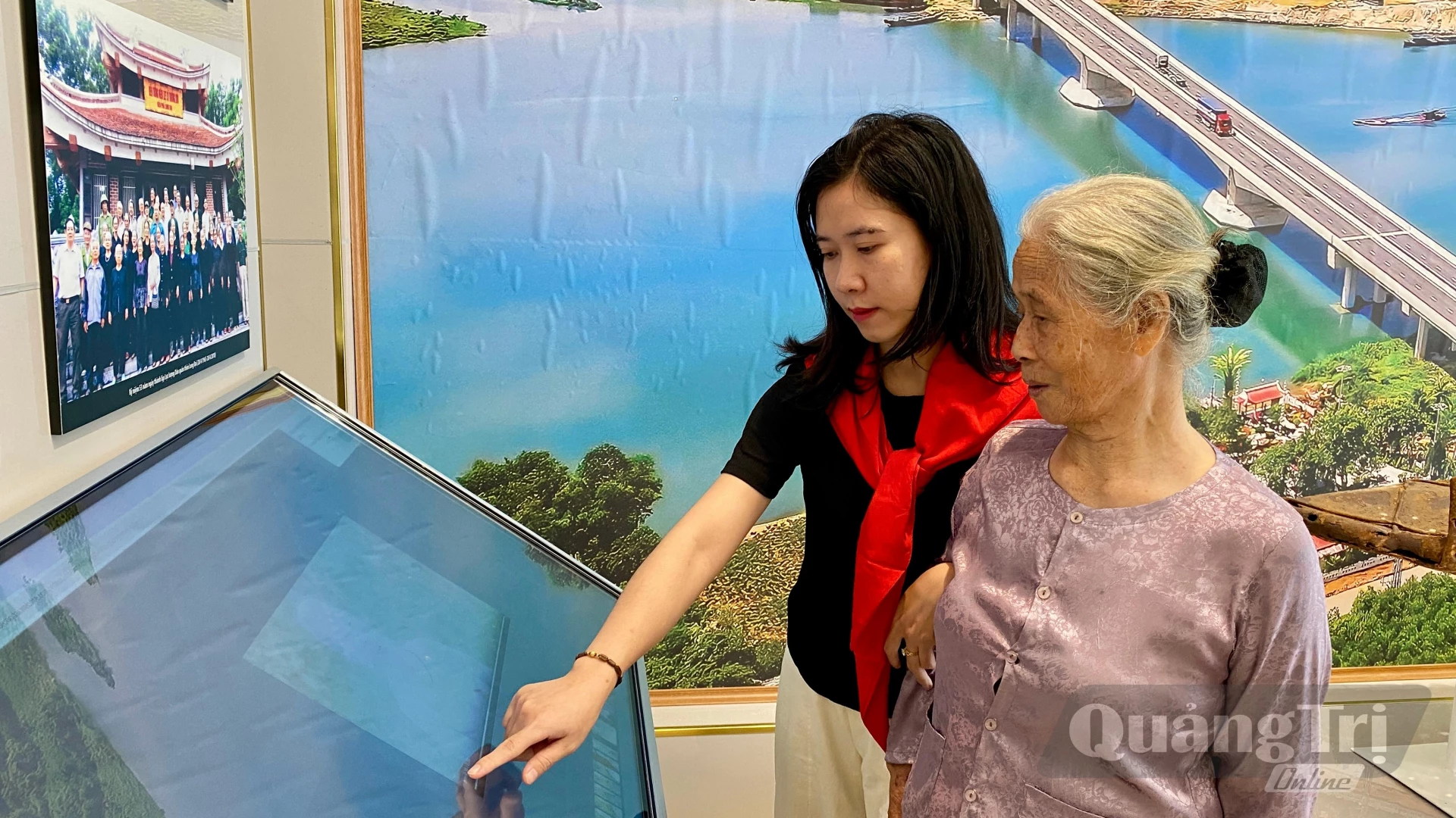 Chị Nguyễn Thị Tuyết Nhung giới thiệu với bà về Khu tưởng niệm 16 thanh niên xung phong hy sinh tại Bến phà II Long Đại - Ảnh: H.N
