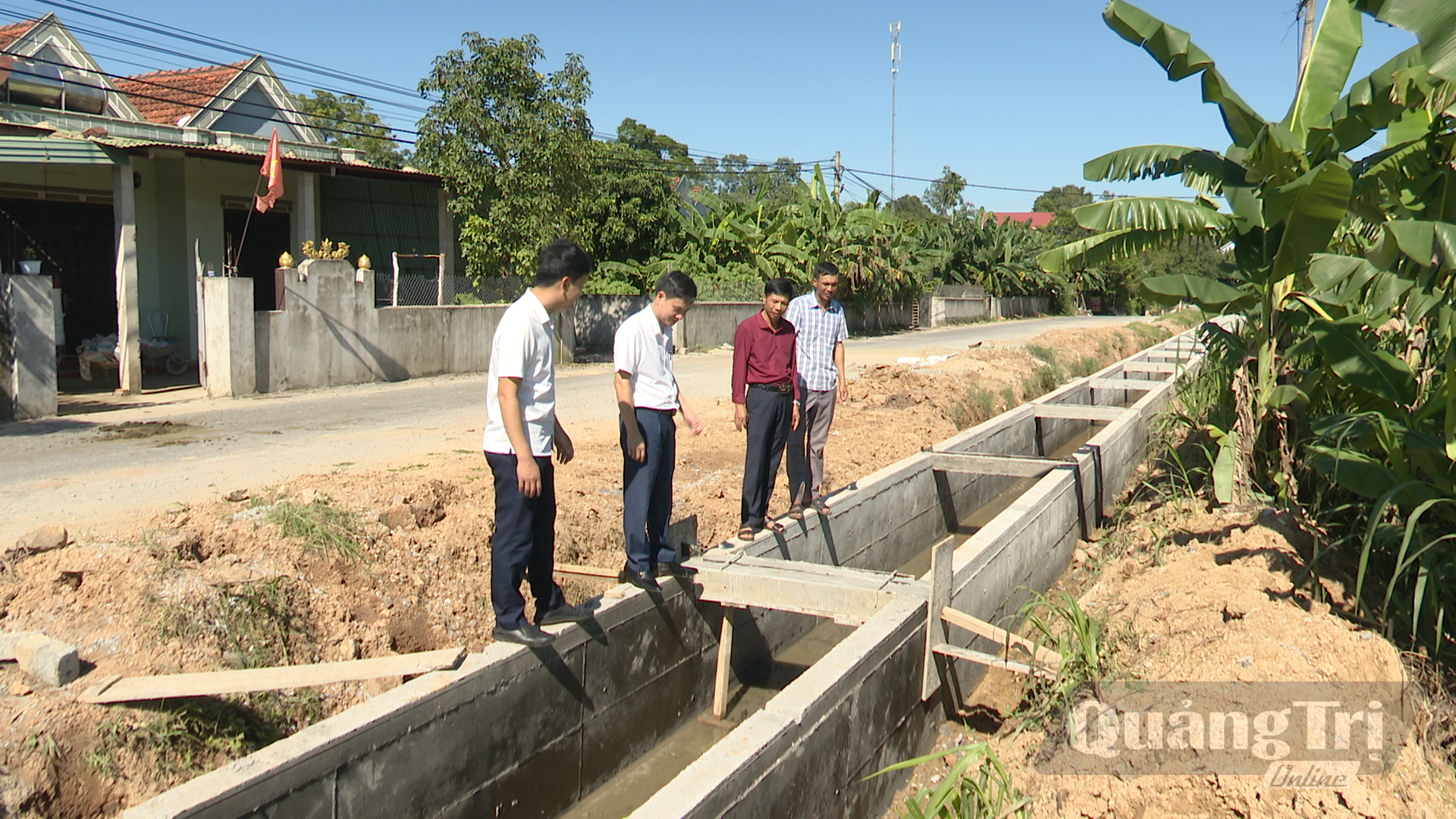 Bí thư Chi bộ thôn Minh Thạch Phan Thanh Phong (ngoài cùng bên trái) kiểm tra kênh mương nội đồng - Ảnh: N.T